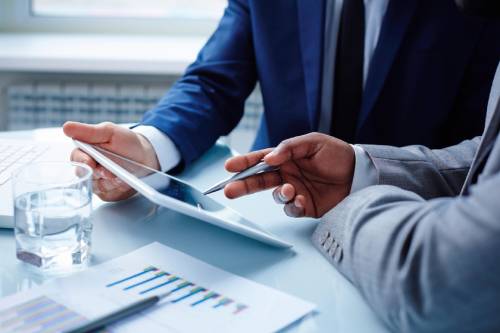 Consultants reviewing data on a tablet